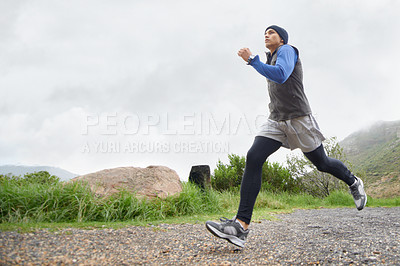 Buy stock photo Trail, runner and man running in nature training, cardio exercise and endurance workout for wellness. Sports, fitness or healthy male athlete on fast jog on mountain outdoors with speed of action