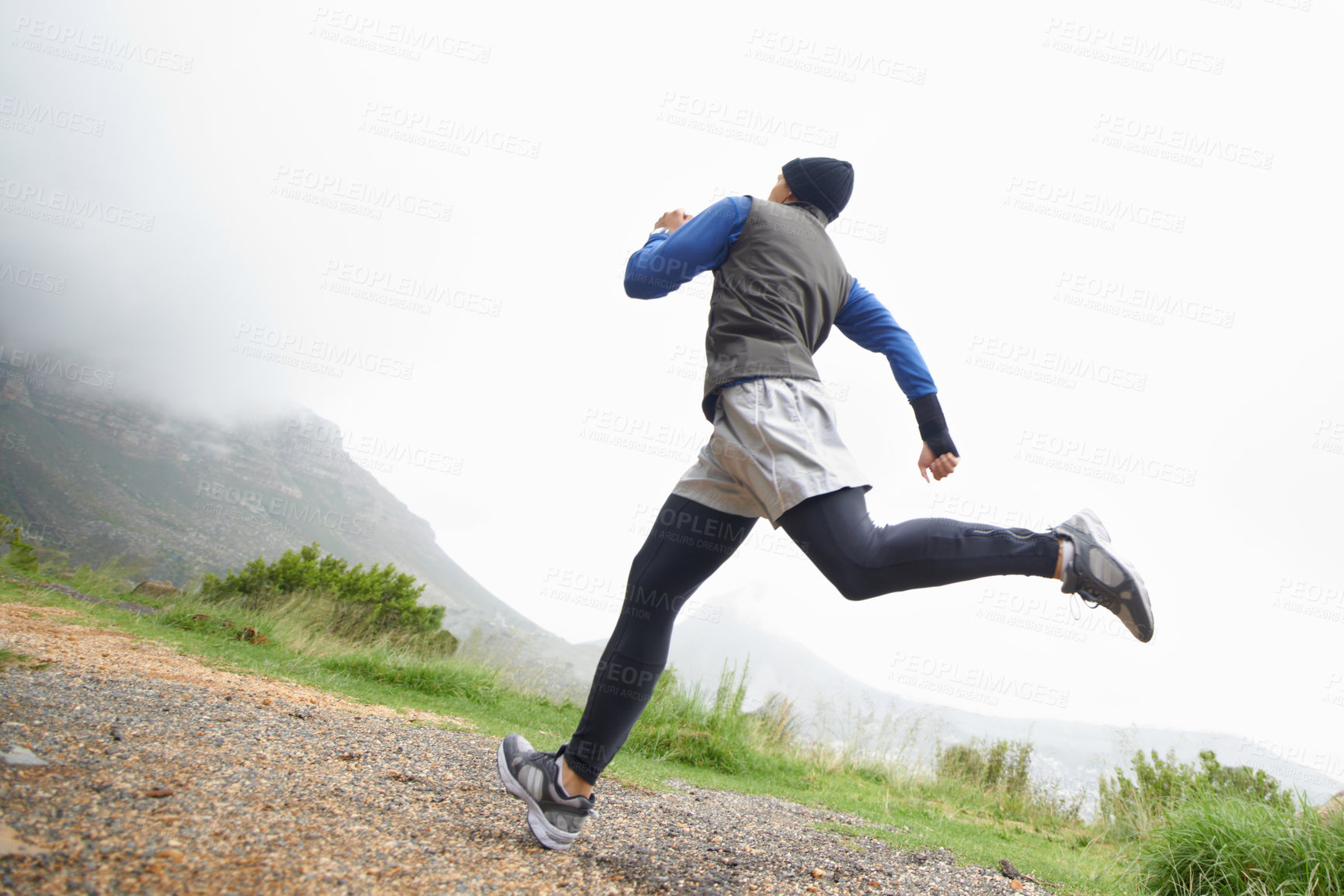 Buy stock photo Low angle, fitness and man running in nature training, cardio exercise or endurance workout for wellness. Sports, runner or back of healthy athlete on fast jog on path outdoors with speed or action 