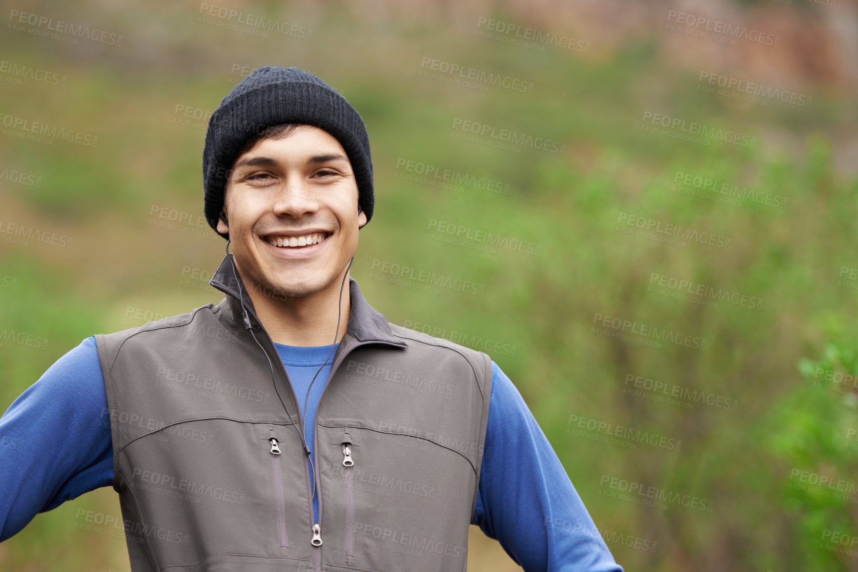 Buy stock photo A handsome young trail runner smiling widely after an invigorating run