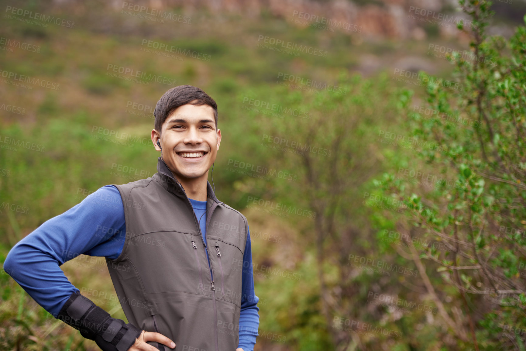 Buy stock photo Earphones, runner or portrait of a happy man in forest for workout, exercise or fitness training in woods. Nature, confident sports person or healthy athlete with radio music audio, wellness or smile