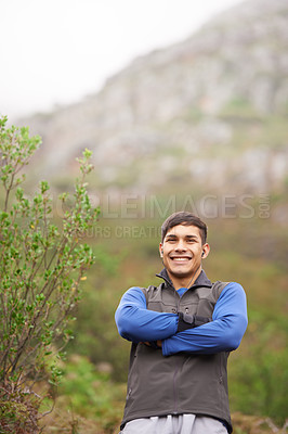Buy stock photo Smile, portrait and a man with arms crossed in nature for fitness, walking and exercise. Happy, morning and a male athlete or person on the mountains with pride for hiking, training or health