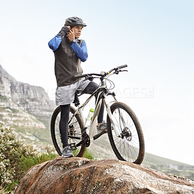 Buy stock photo A young mountain biker fastening his helmet