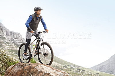 Buy stock photo Man, mountain bike and off road cycling with mockup space on nature adventure or fitness in outdoor extreme sport. Male person or cyclist on bicycle for cardio on cliff hill in exercise with blue sky