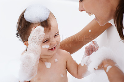 Buy stock photo Baby, bath and mother laughing in a bathroom with cleaning, foam and help with love and support. Care, mom and young child with soap in a home with bonding and washing for wellness and hygiene