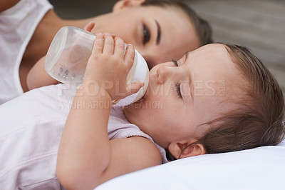 Buy stock photo Calm, happy and a mother with a baby and milk for nutrition, health and growth development. Morning, family and a young mom and child with a bottle in the bedroom of a house for food and a drink