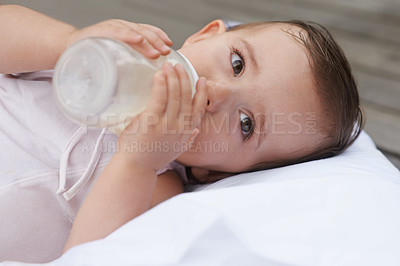 Buy stock photo Baby, kid and drinking bottle for nutrition, liquid food and  relaxing together on porch at home. Girl, toddler and formula for health or child development in outdoors, feeding and milk for wellness