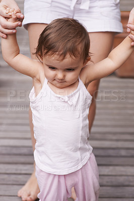 Buy stock photo Mother, outdoors and baby learning to walk, support and teaching toddler for child development or growth. Mommy, girl and trust in parent and childcare, security and education for skills on deck