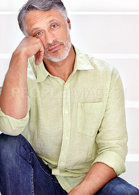 Buy stock photo A handsome mature man sitting on a staircase
