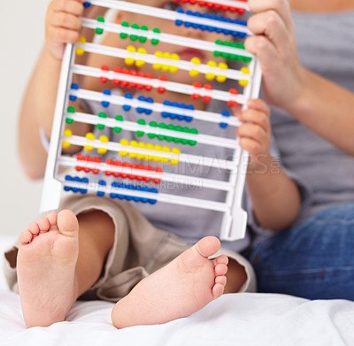 Buy stock photo Abacus, math and baby with mother playing, learning and teaching for child development on bed. Bonding, toy and closeup of mom teaching kid, infant or toddler with counting in bedroom at home.