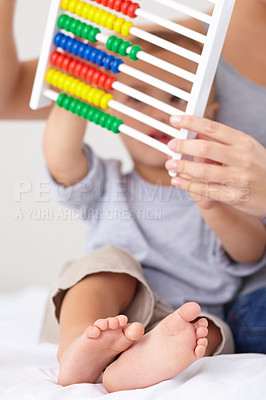 Buy stock photo Abacus, math and baby with mother playing, learning and teaching for child development on bed. Bonding, toy and closeup of mom with kid, infant or toddler with counting together in bedroom at home.