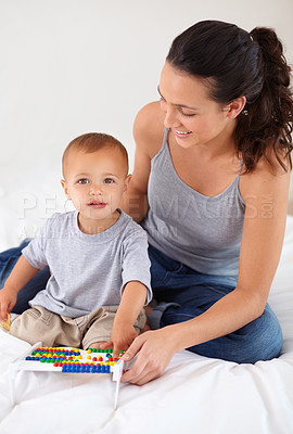 Buy stock photo Abacus, portrait and baby with mother playing, learning and education for child development on bed. Bonding, toy and young mom teaching kid, infant or toddler counting for math in bedroom at home