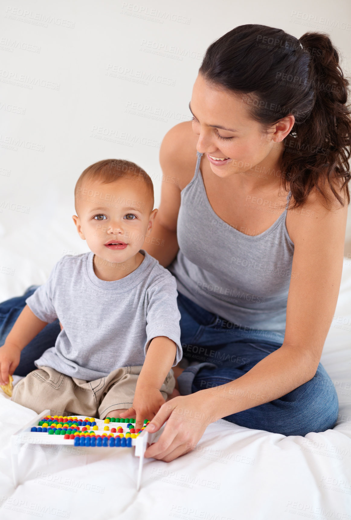 Buy stock photo Abacus, portrait and baby with mother playing, learning and education for child development on bed. Bonding, toy and young mom teaching kid, infant or toddler counting for math in bedroom at home