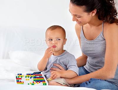 Buy stock photo Abacus, relax and baby with mother playing, learning and teaching for child development on bed. Bonding, toy and closeup of mom teaching kid, infant or toddler with counting in bedroom at home.