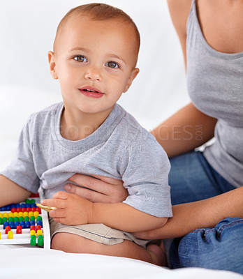 Buy stock photo Abacus, smile and portrait of baby with mother playing, learning and teaching for child development on bed. Bonding, toy and mom with kid, infant or toddler with counting in bedroom at home.
