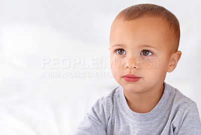 Buy stock photo Thinking, cute and boy baby on bed in the nursery of modern home relaxing and sitting. Calm, mockup and serious young kid, infant or toddler with child development for growth in bedroom at house.