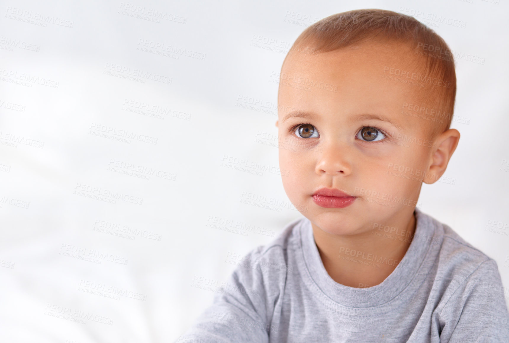 Buy stock photo Thinking, cute and boy baby on bed in the nursery of modern home relaxing and sitting. Calm, mockup and serious young kid, infant or toddler with child development for growth in bedroom at house.