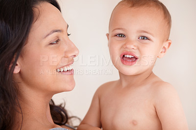 Buy stock photo Family, relax and mother with baby on a white background for bonding, relationship and happy together. Love, youth and portrait of mom carrying kid for growth, playing and child development in studio