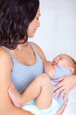 Buy stock photo Mom holding toddler in home with crying, comfort and child care with support in morning. Happy woman, tired baby boy and nap time together in bedroom with sleep, trust and safety in mothers love.