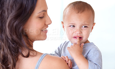 Buy stock photo Mom holding crying baby boy in home with comfort, bonding and child care in morning. Happy woman, sad toddler and security together in bedroom with development, trust and safety with mothers love.