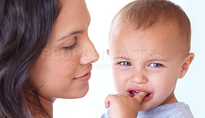 Buy stock photo Family, crying and mother with baby on a white background for bonding, empathy and comfort. Love, youth and mom with sad or upset kid for relationship, wellness and child development in studio