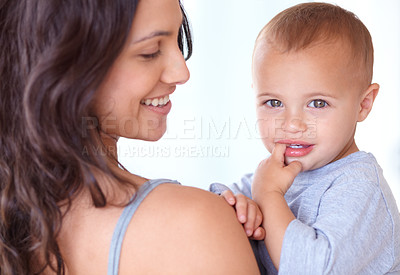 Buy stock photo Family, happy and mother with baby on a white background for bonding, relationship and relax together. Love, youth and portrait of mom carrying kid for growth, playing and child development in studio