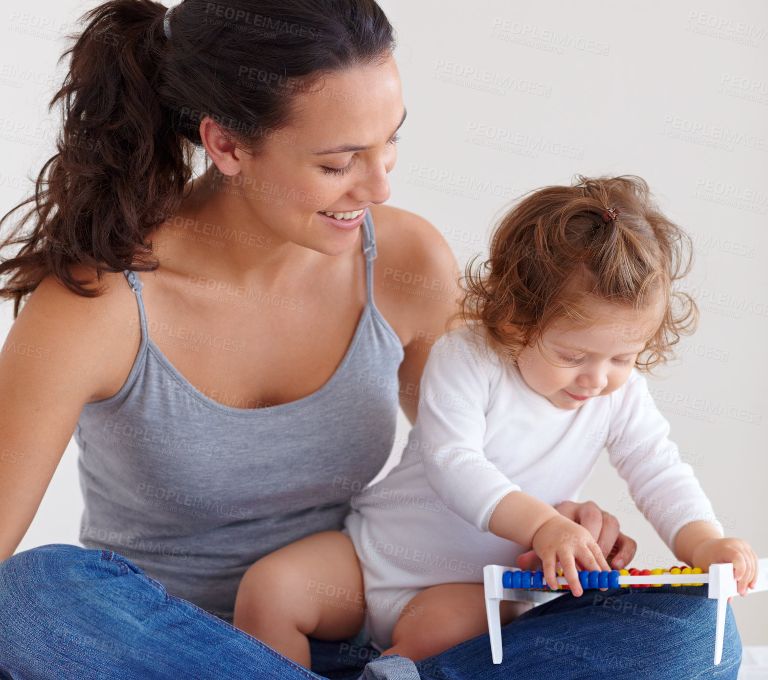 Buy stock photo Mom playing with happy baby in home with toys, bonding and child care with support in morning on bed. Woman, playful toddler girl and fun together in bedroom with development, smile and abacus.