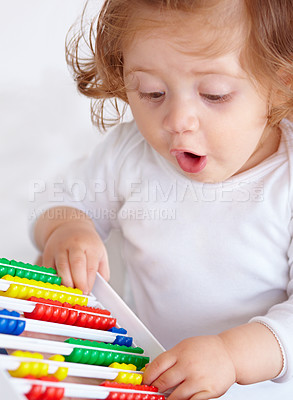 Buy stock photo Abacus, surprise and girl baby learning, playing and teaching for child development on bed. Maths, toy and closeup of young kid, infant or toddler counting for education in bedroom at modern home.
