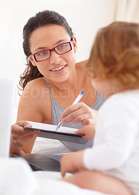 Buy stock photo Mom, playing and drawing on notebook with baby in home or bedroom with a pen. Happy, mother and child on bed with writing in notepad for fun, games or learning to sketch a doodle together in house