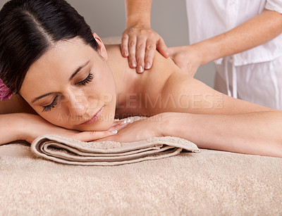 Buy stock photo Relaxed young woman receiving a massage at a day spa