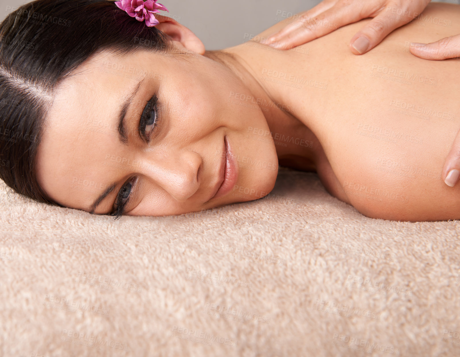 Buy stock photo Smiling young woman enjoying a massage at a day spa