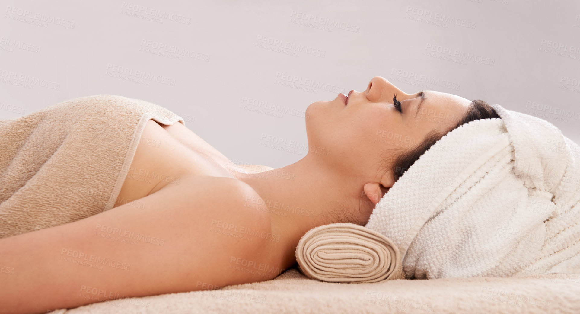 Buy stock photo Side view of a gorgeous young woman lying in a day spa