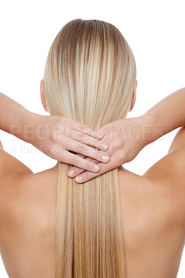 Buy stock photo Rear view of a young blonde woman holding her hair against a white backgrouhnd