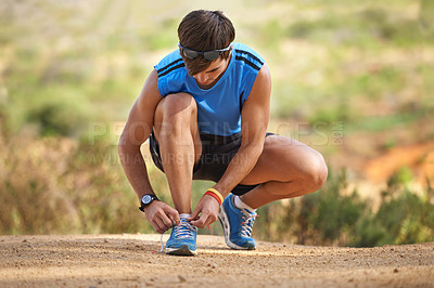 Buy stock photo Fitness, shoes and man prepare before running in nature for health, wellness and exercise. Shoes, tying laces and getting ready with athletic man preparing for workout, training and jog or hike 