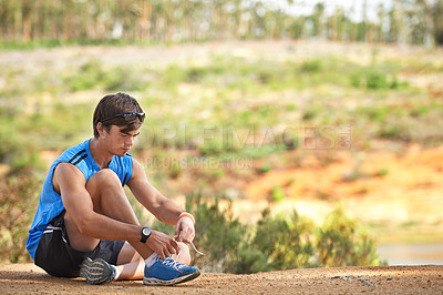 Buy stock photo Sports, man and shoes on a floor by runner start fitness, running and cardio exercise in a forest, calm and ready. Health, athlete and sport guy lace tie on ground before marathon training in nature