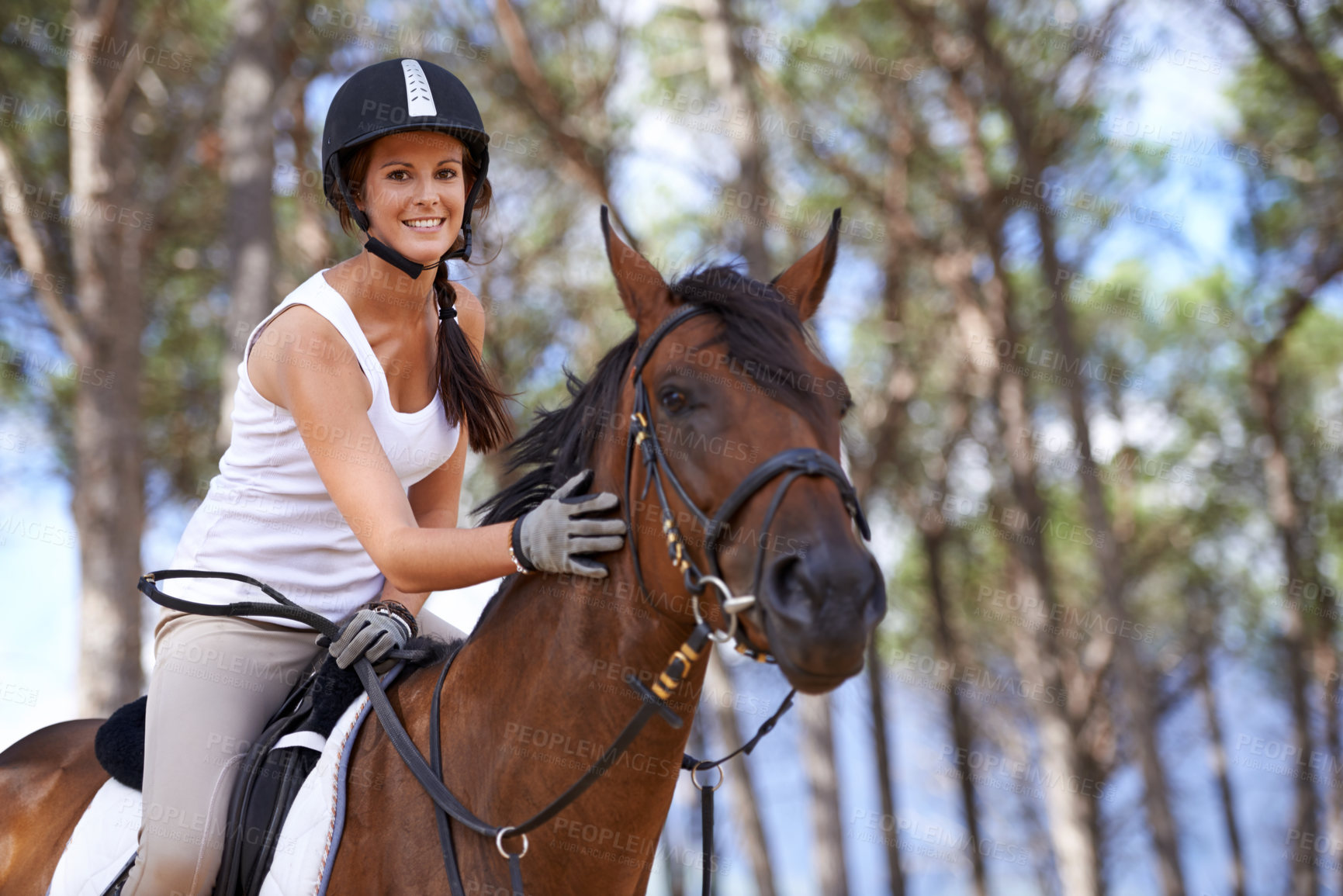Buy stock photo An attractive young woman on horseback 