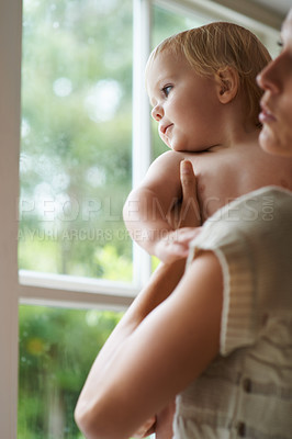 Buy stock photo A baby boy and his mother looking out the window
