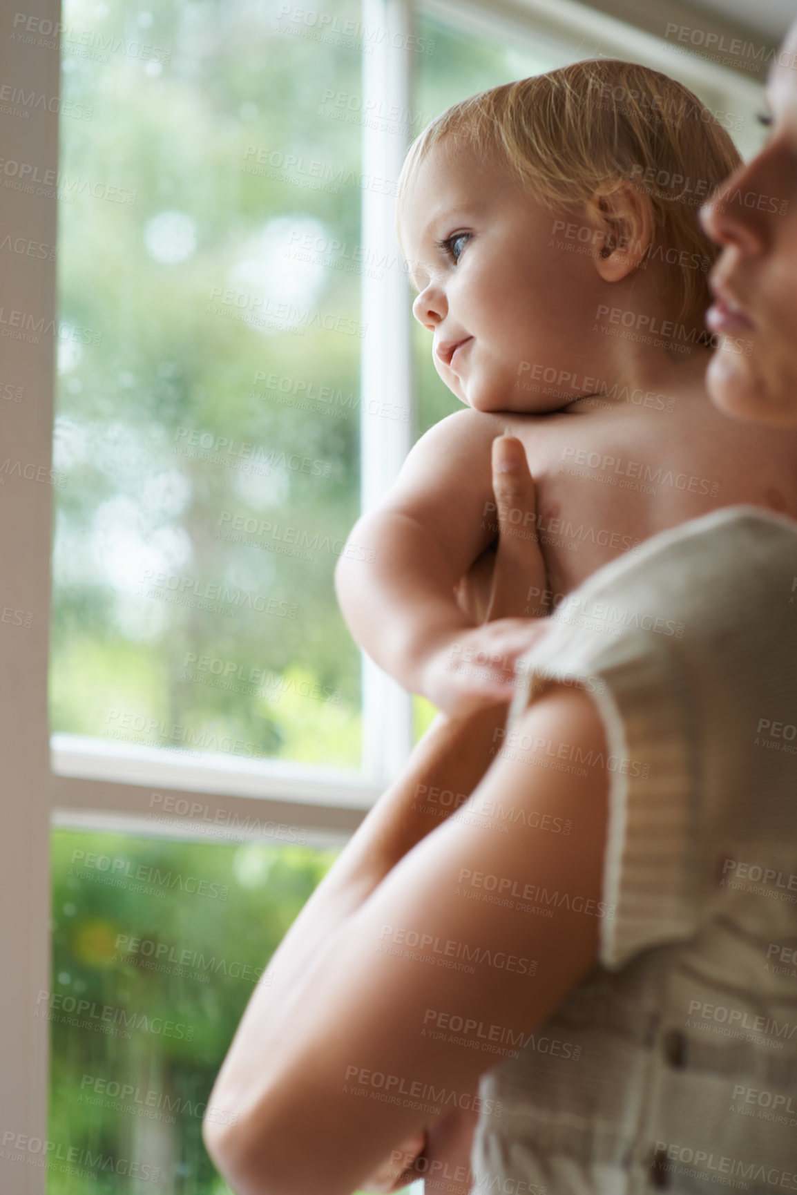 Buy stock photo A baby boy and his mother looking out the window