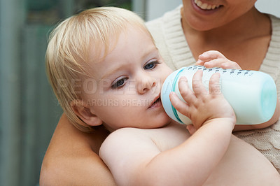 Buy stock photo Relax, sweet and baby drinking bottle and laying with mother for milk and bonding together. Cute, growth and infant, kid or toddler enjoying a beverage for nutrition, health and child development.