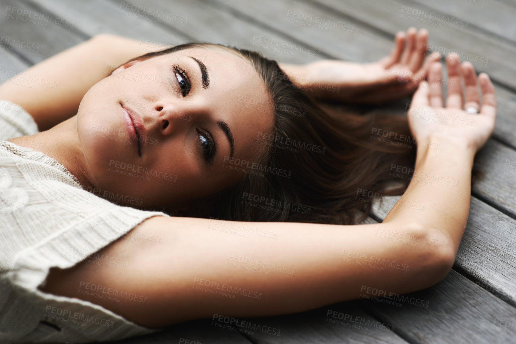Buy stock photo An attractive young woman lying on her porch
