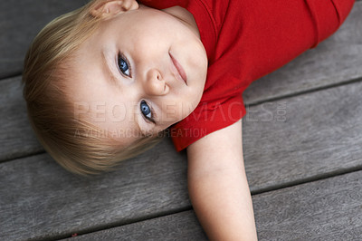 Buy stock photo Baby, playing on floor outdoor for development with portrait, curiosity or early childhood in backyard of home. Toddler, child and relax on ground for wellness, milestone and exploring or aerial view