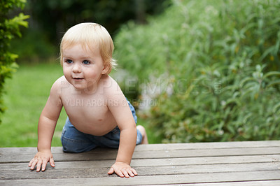 Buy stock photo A baby boy crawling on the stoop in the backyard