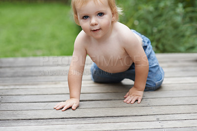 Buy stock photo Baby, portrait on floor outdoor for development with relax, curiosity and early childhood in backyard of home. Toddler, child and crawling on ground for wellness, milestone and exploring with playing