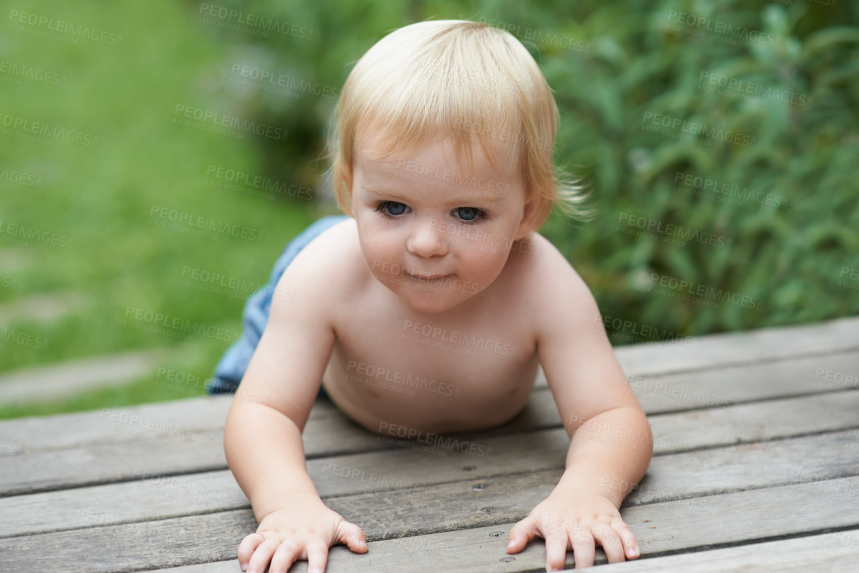 Buy stock photo Baby, relax and floor outdoor for development with playing, curiosity or early childhood in backyard of home. Toddler, child and crawling on ground for wellness, milestone or exploring with innocence