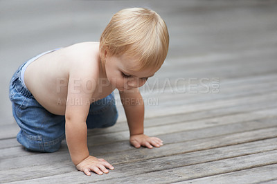 Buy stock photo Toddler, playing on floor outdoor for development with relax, curiosity and early childhood in backyard of home. Baby, child and crawling on ground for wellness, milestone or exploring with innocence