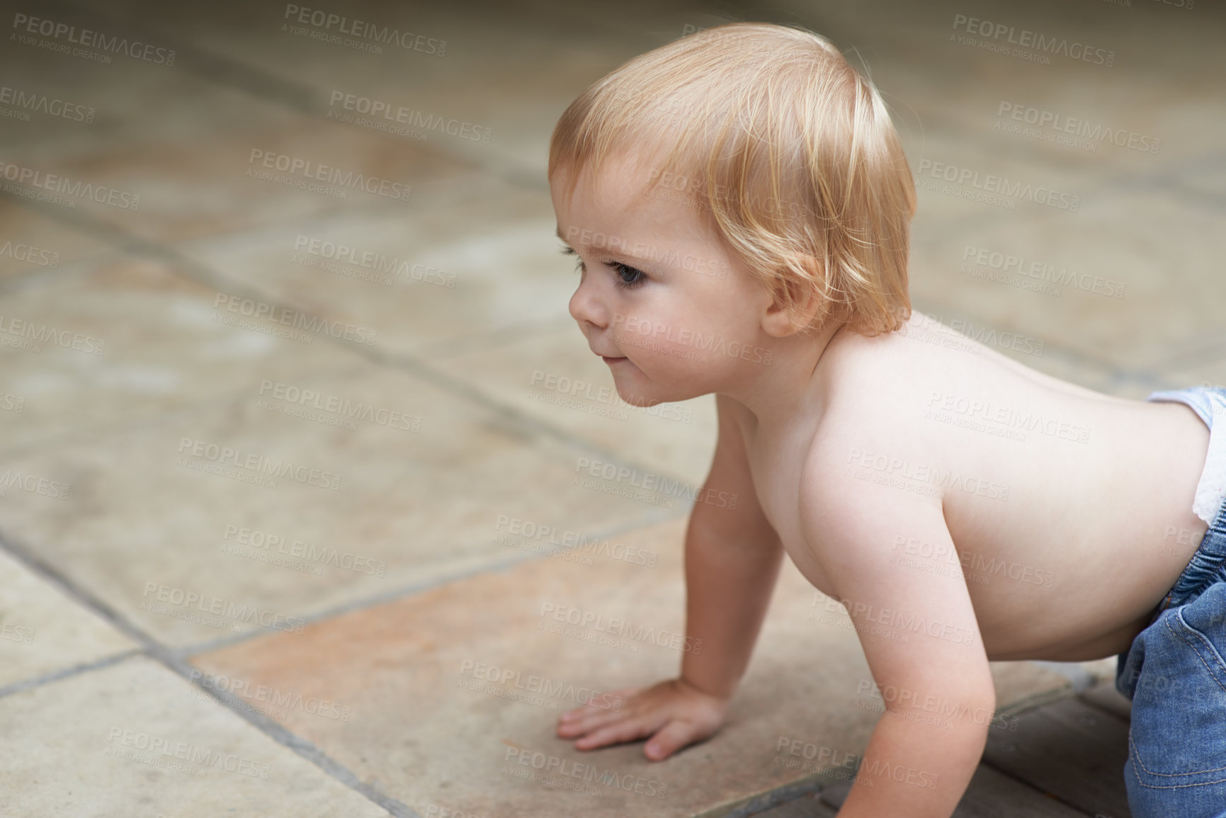 Buy stock photo A sweet little baby boy crawling outside