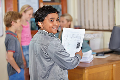 Buy stock photo Portrait, child and smile of student with paper in classroom for assignment or class test. Happiness, education and Indian kid with document for studying, learning and assessment in primary school.