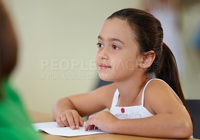 Buy stock photo An eager school girl sitting at her desk