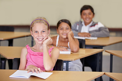 Buy stock photo Portrait, kids and smile of student in classroom with book, ready to learn and study in class. Group of students, education and girl learning in primary school for knowledge, development or studying.