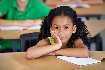 Buy stock photo Portrait, kid and bored student in classroom with book, ready to learn and study in class. Boredom, education and serious Indian girl learning in primary school for knowledge, development or studying