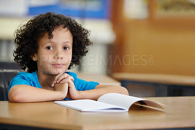 Buy stock photo Class, notebook and portrait of child at desk, learning and education with school exam project. Book, studying for test and boy student in classroom with knowledge, information and future opportunity